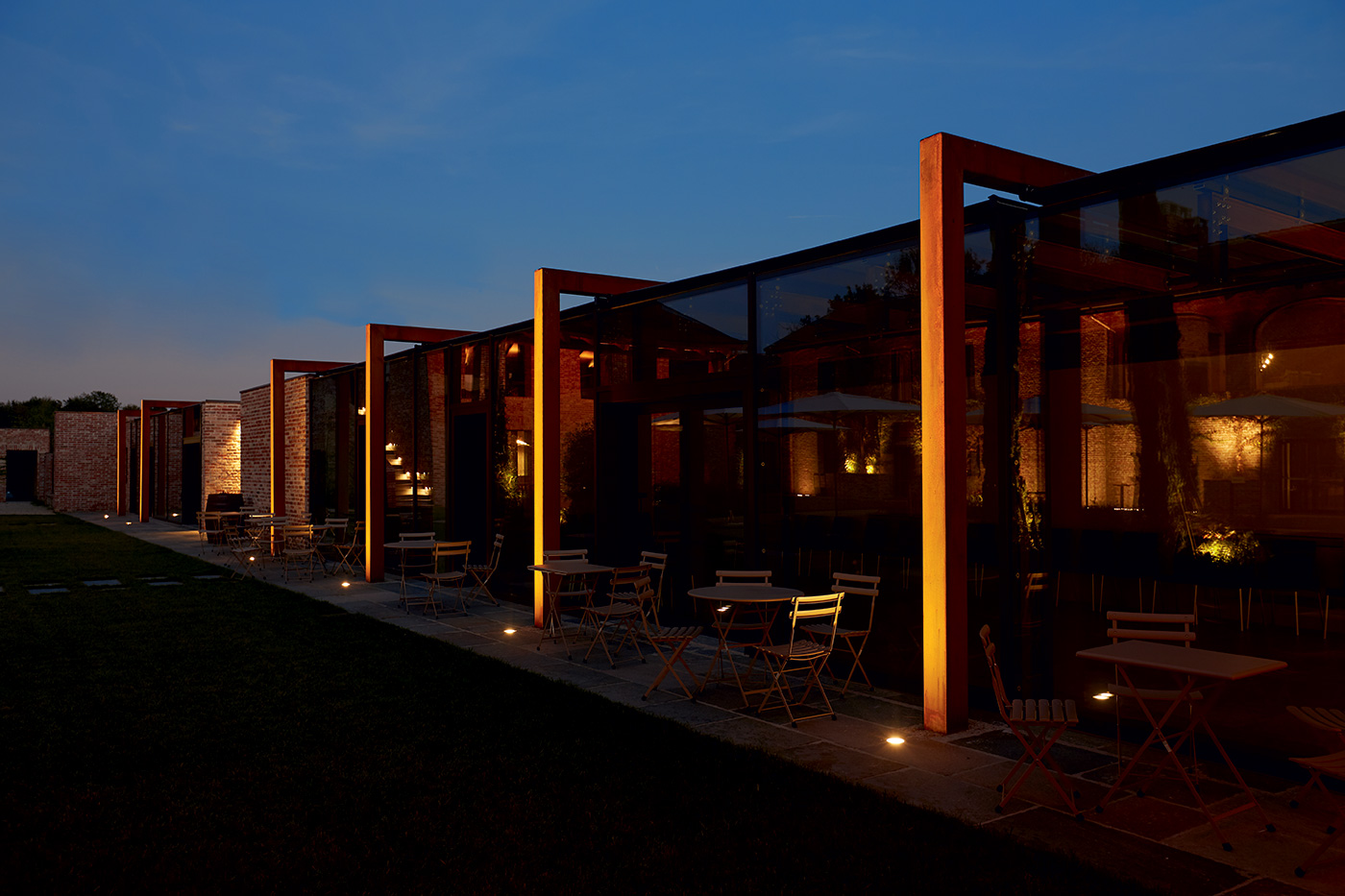 Cascina Ranverso turns a long facade into a measured evening rhythm.